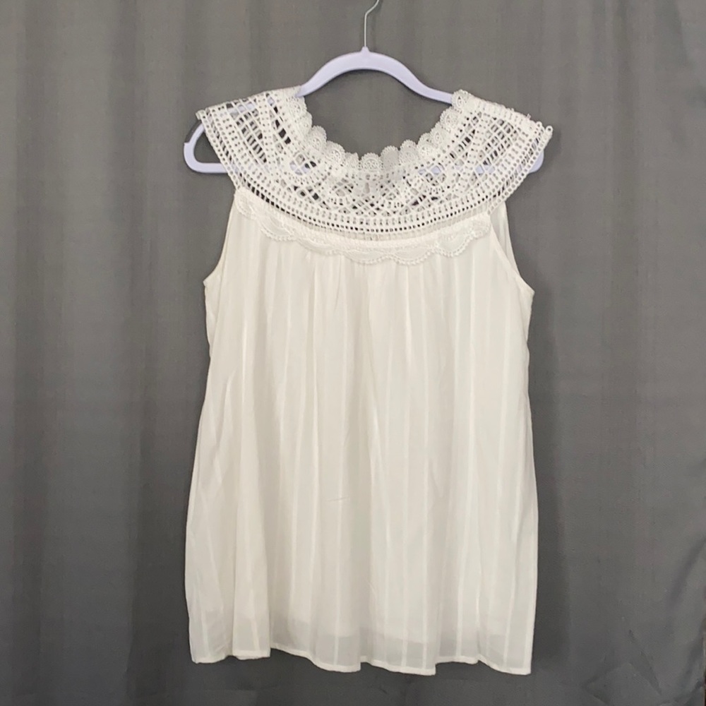 Sleeveless top with crocheted neck.